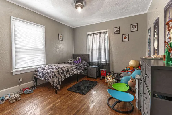 a bedroom with bed and a window
