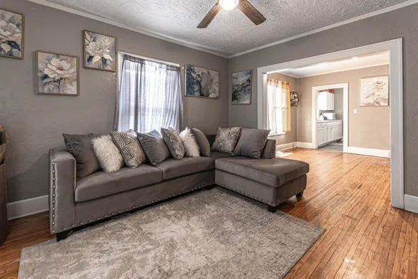 a living room with furniture and wooden floor