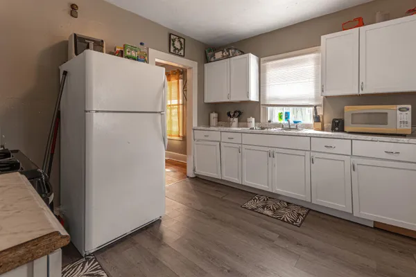 a kitchen with cabinets a refrigerator and a stove