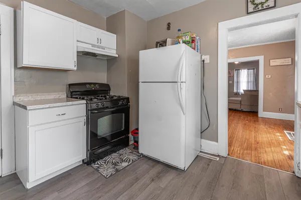 a kitchen with a refrigerator and a stove top oven