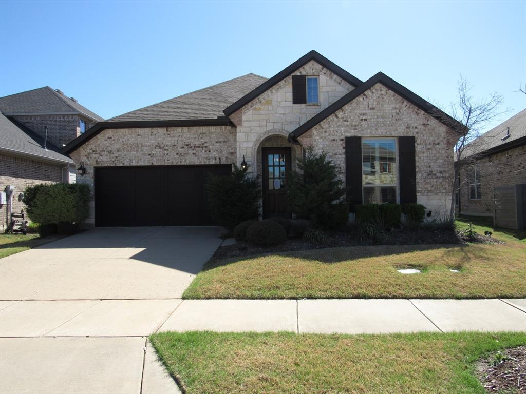 816 Pier Street Little Elm, TX 76227 - Photo 1 of 27 French provincial home featuring brick siding, a front yard, driveway, and an attached garage