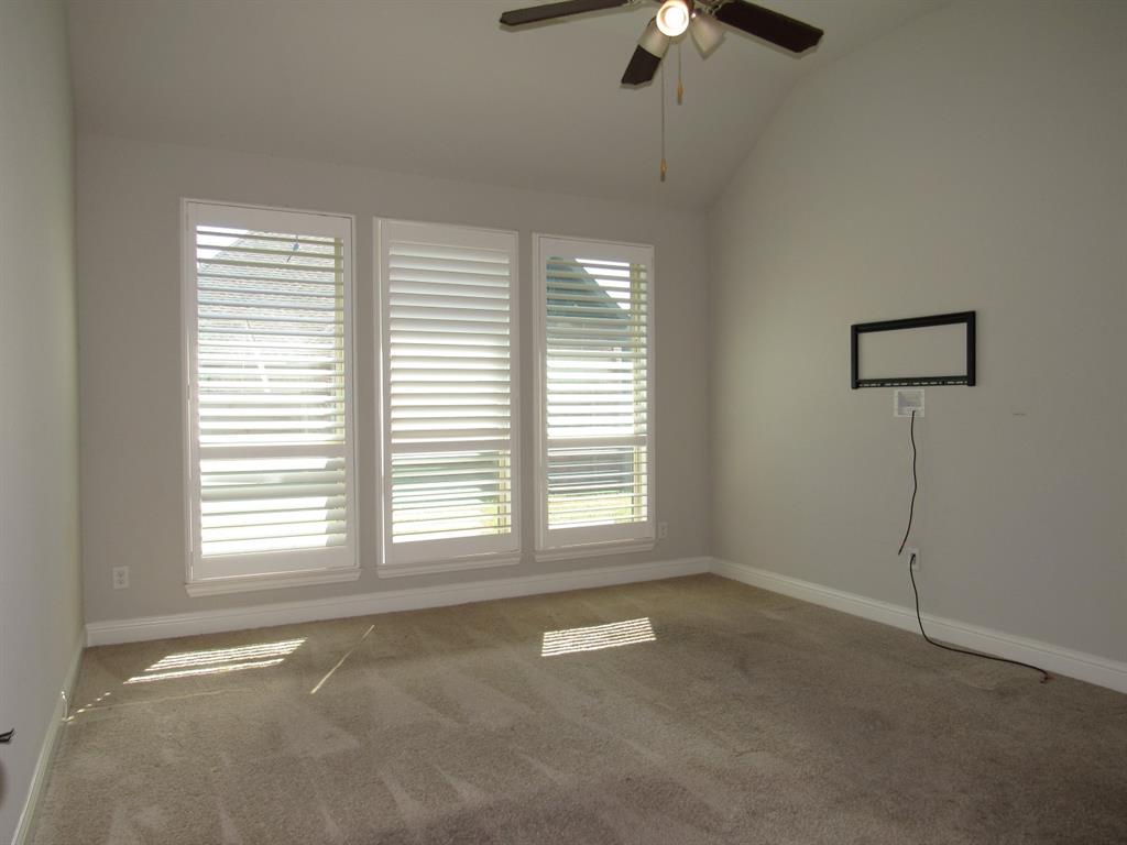 816 Pier Street Little Elm, TX 76227 - Photo 16 of 27 Primary bedroom featuring a ceiling fan, carpet floors, and vaulted ceiling