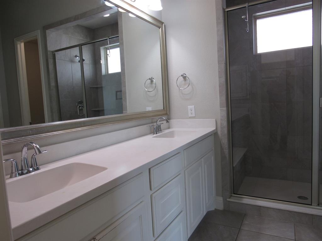 816 Pier Street Little Elm, TX 76227 - Photo 18 of 27 Full bath with double vanity, a shower stall, and light tile patterned flooring