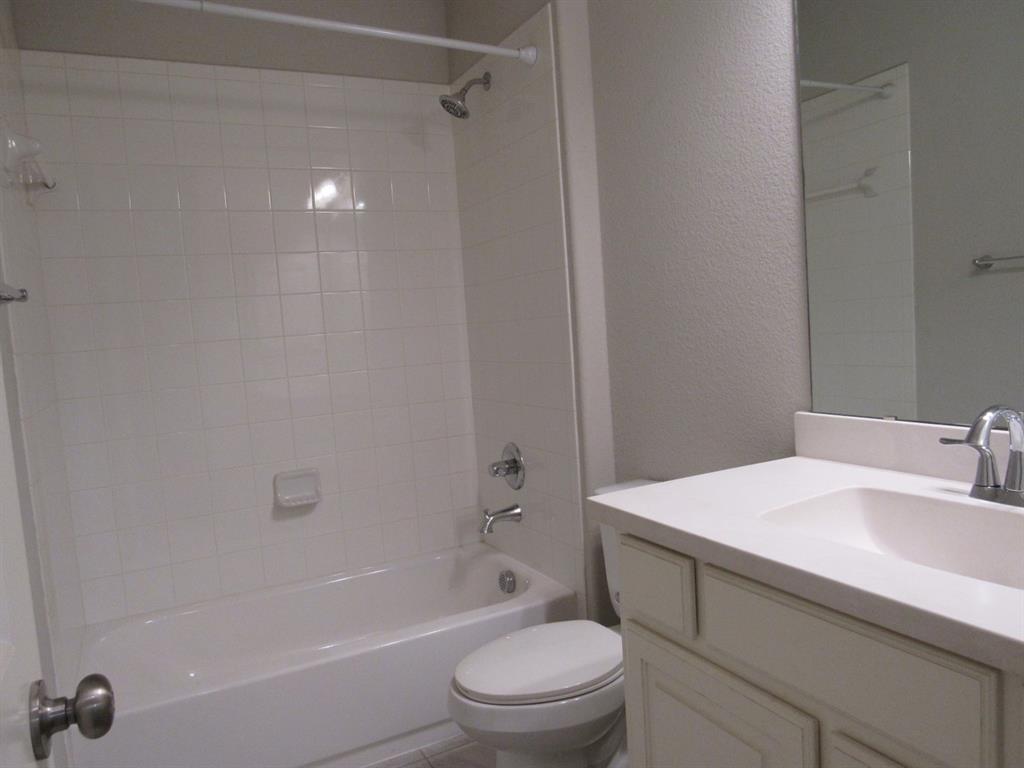 816 Pier Street Little Elm, TX 76227 - Photo 21 of 27 Full bathroom for bedrooms 3 and 4 with a textured wall, vanity, and bathtub / shower combination