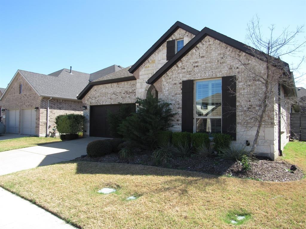 816 Pier Street Little Elm, TX 76227 - Photo 24 of 27 French country home with a front yard, brick siding, an attached garage, concrete driveway, and roof with shingles