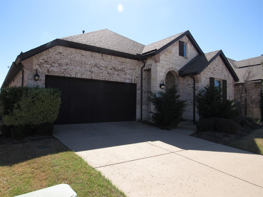 816 Pier Street Little Elm, TX 76227 - Photo 26 of 27 French provincial home featuring a garage, driveway, and brick siding