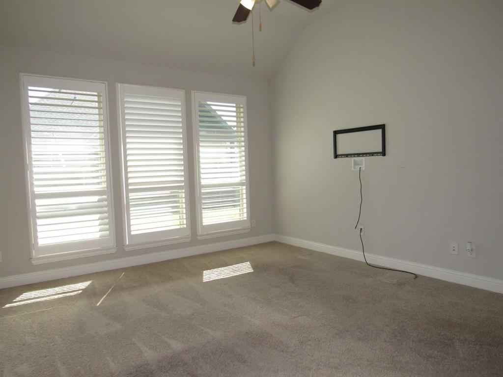 816 Pier Street Little Elm, TX 76227 - Photo 4 of 27 Carpeted empty room with ceiling fan and lofted ceiling