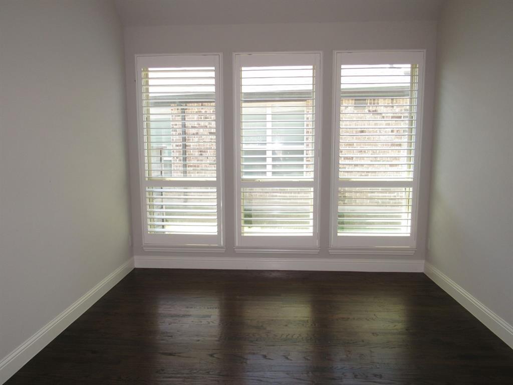 816 Pier Street Little Elm, TX 76227 - Photo 5 of 27 Empty room with dark wood-style floors and baseboards
