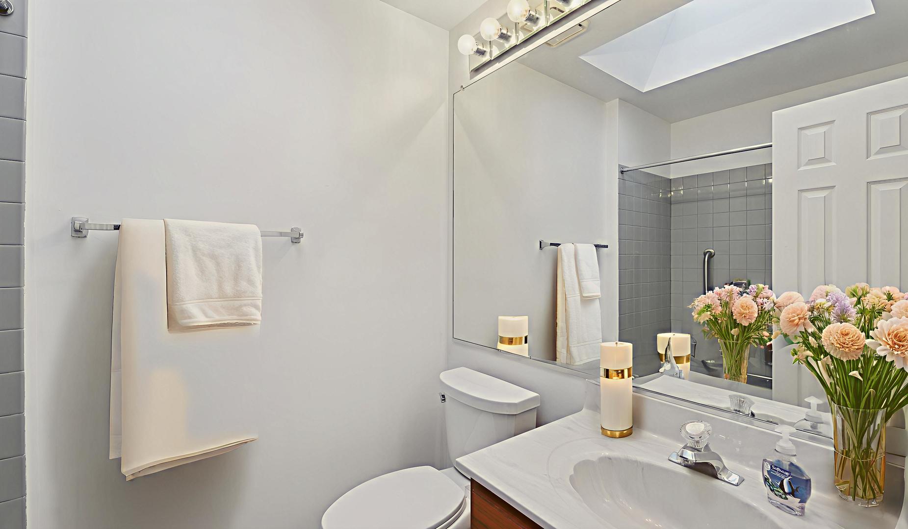 -n155 Windermere Road, Unit 1005 Winfield, IL 60190 - Photo 10 of 16 a bathroom with a sink toilet and shower