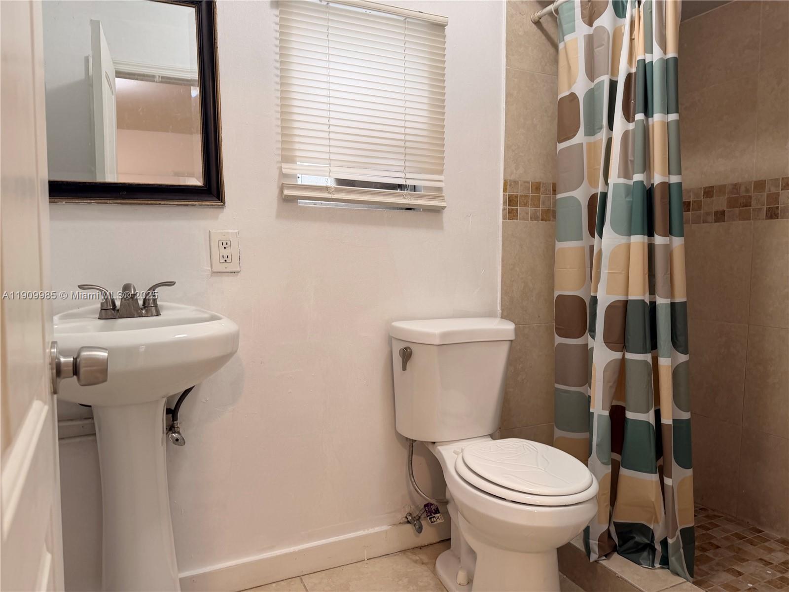 2412 Northwest 34th Street, Unit 3 Miami, FL 33142 - Photo 11 of 15 a bathroom with a sink and a toilet