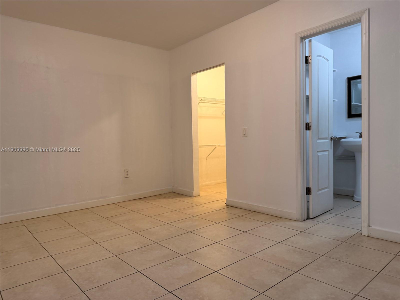 2412 Northwest 34th Street, Unit 3 Miami, FL 33142 - Photo 4 of 15 an empty room with windows
