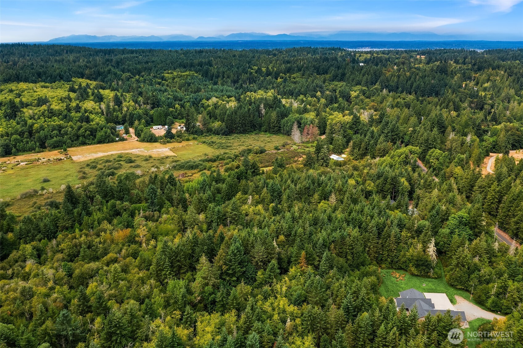 0 Cornwall Road Northwest Lakebay, WA 98349 - Photo 1 of 14 a view of a city with lush green forest