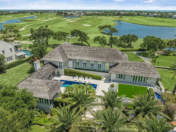 a view of a swimming pool with lawn chairs and a potted plants