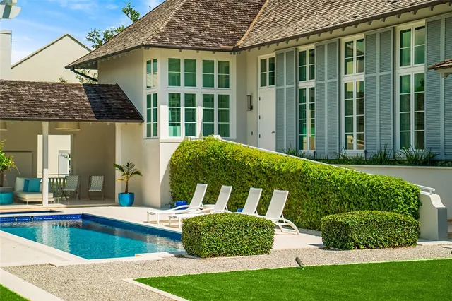 a view of a house with a yard and sitting area