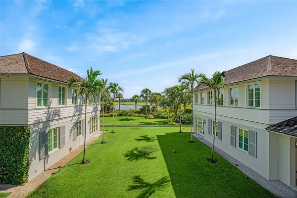 a view of an house with backyard and a garden
