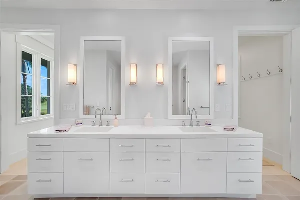 a bathroom with double sink and a mirror