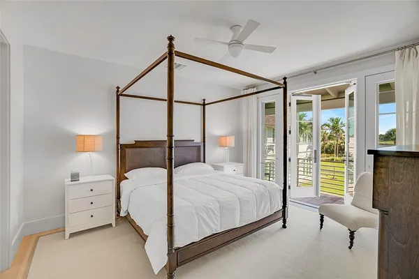 a bedroom with a bed and large window