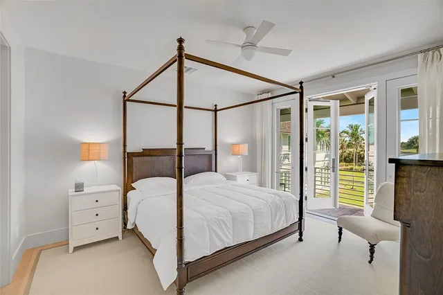 a bedroom with a bed and large window