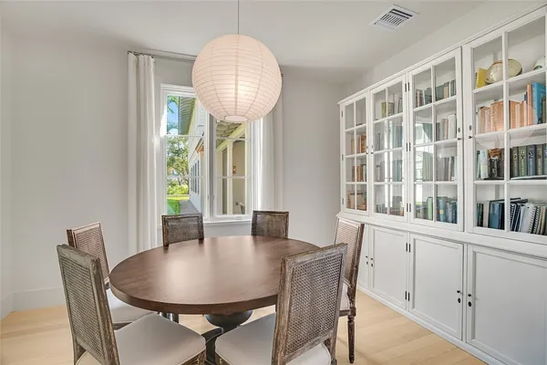 a view of a dining room with furniture window and wooden floor