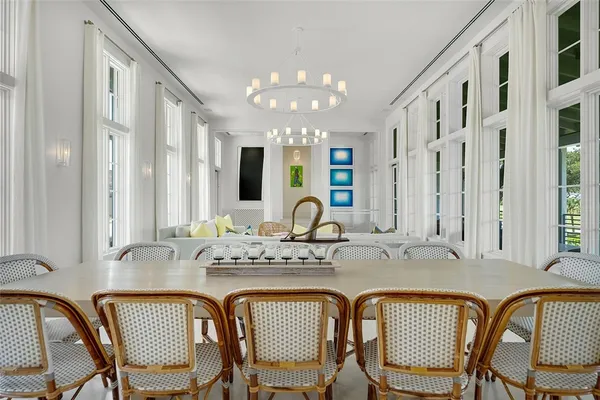a view of a dining room with furniture and chandelier