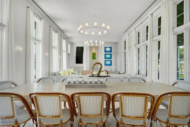 a view of a dining room with furniture and chandelier