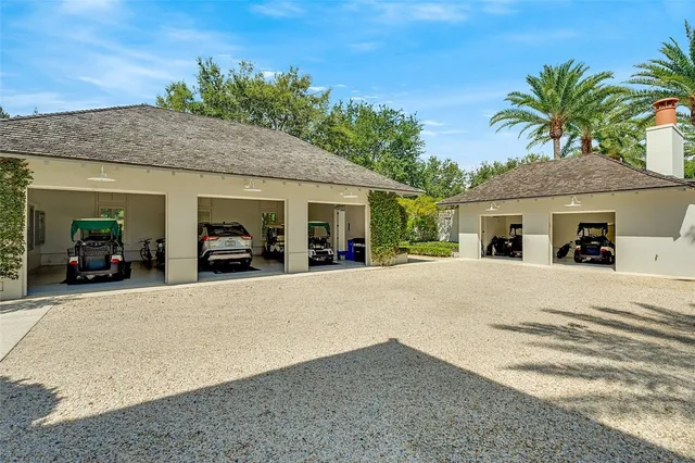 a view of a house with a yard and palm trees