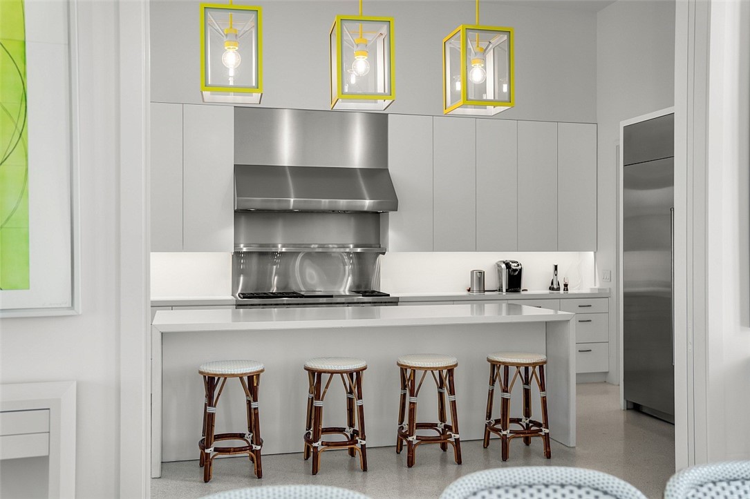 3340 Savannah Drive Vero Beach, FL 32963 - Photo 5 of 35 a kitchen with stainless steel appliances a table and chairs in it