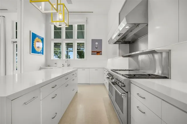 a kitchen with stainless steel appliances granite countertop a stove and a sink