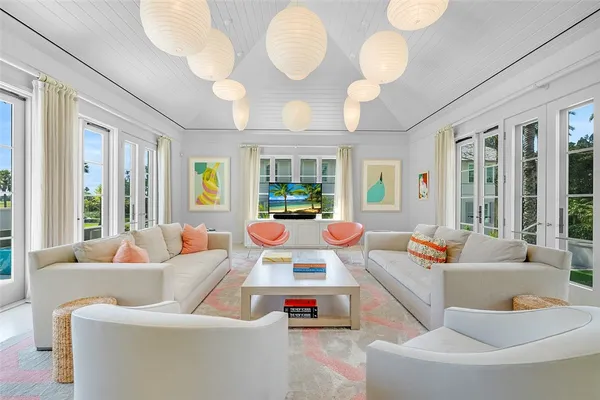 a living room with patio furniture and a large window