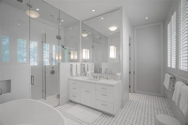 a bathroom with a double vanity sink mirror double and shower