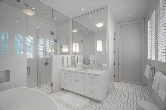 a bathroom with a double vanity sink mirror double and shower