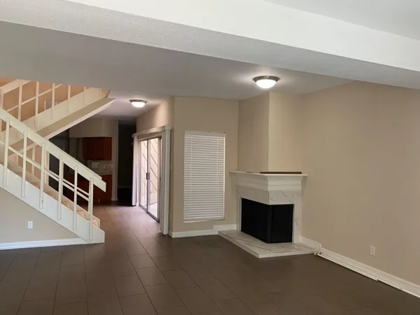 a view of a livingroom with an empty space and a fireplace
