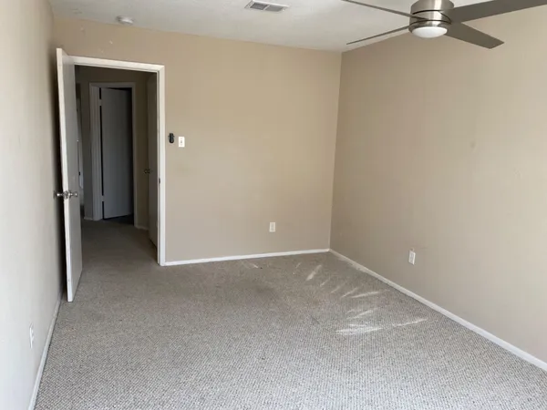 a view of an empty room with a closet