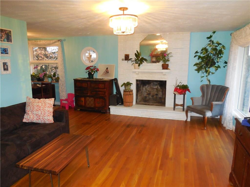 551 Allendale Road Rochester, PA 15074 - Photo 16 of 22 Living room has hardwoods and fireplace.