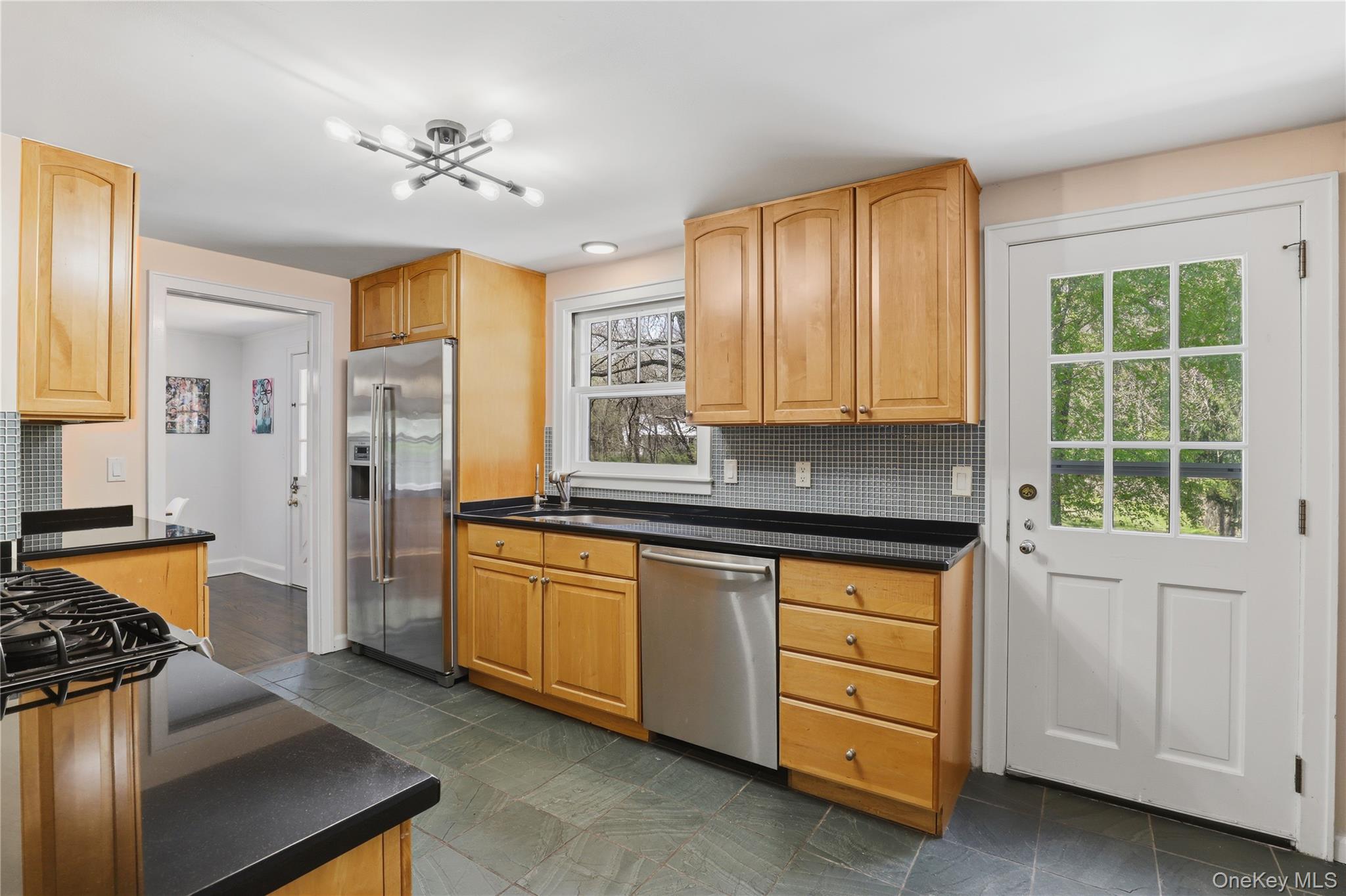 576 Old Post Road Bedford, NY 10506 - Photo 15 of 29 a kitchen with stainless steel appliances granite countertop a sink and a stove