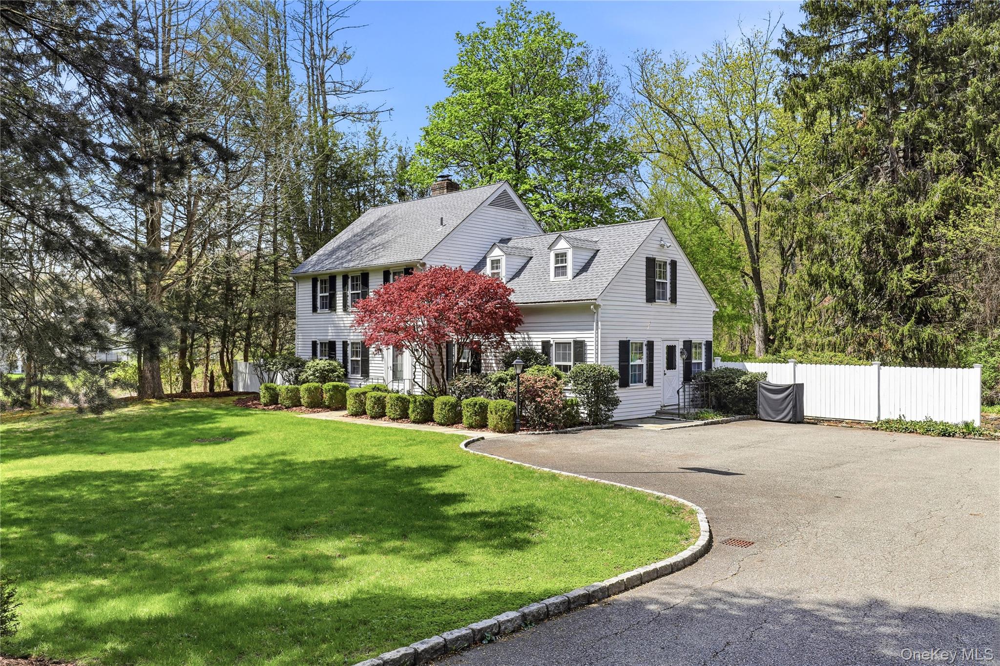 576 Old Post Road Bedford, NY 10506 - Photo 2 of 29 a front view of a house with a garden