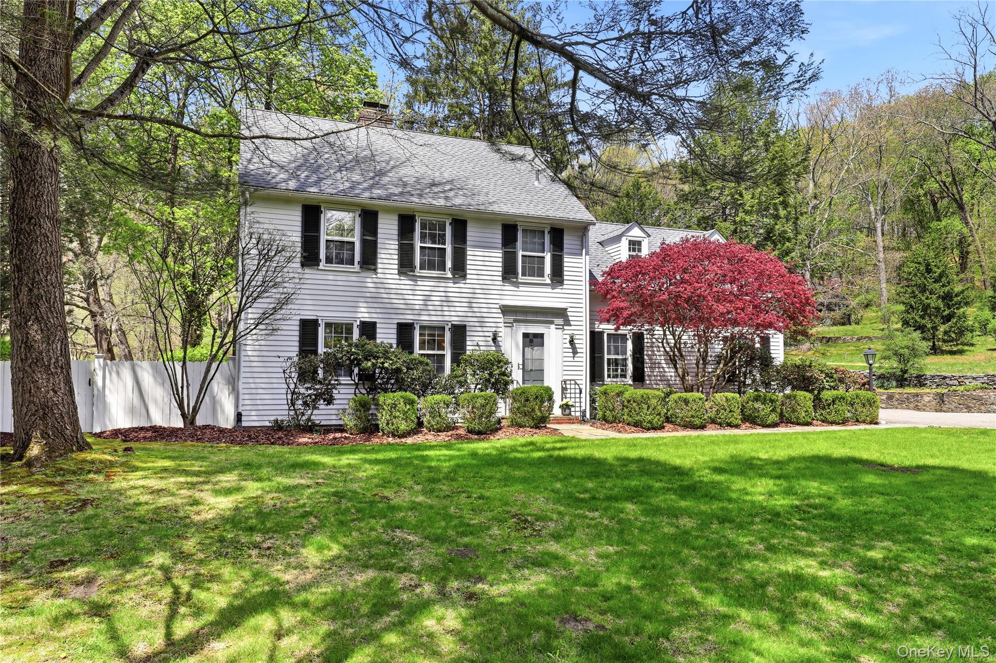 576 Old Post Road Bedford, NY 10506 - Photo 3 of 29 a front view of a house with garden