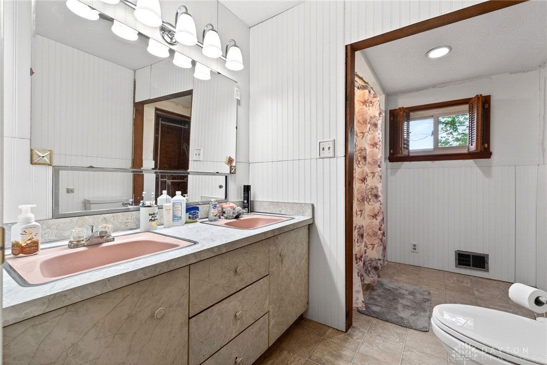 2470 Clark Run Road Xenia, OH 45385 - Photo 27 of 57 This functional bathroom offers dual sinks, ample vanity space, and a shower area.