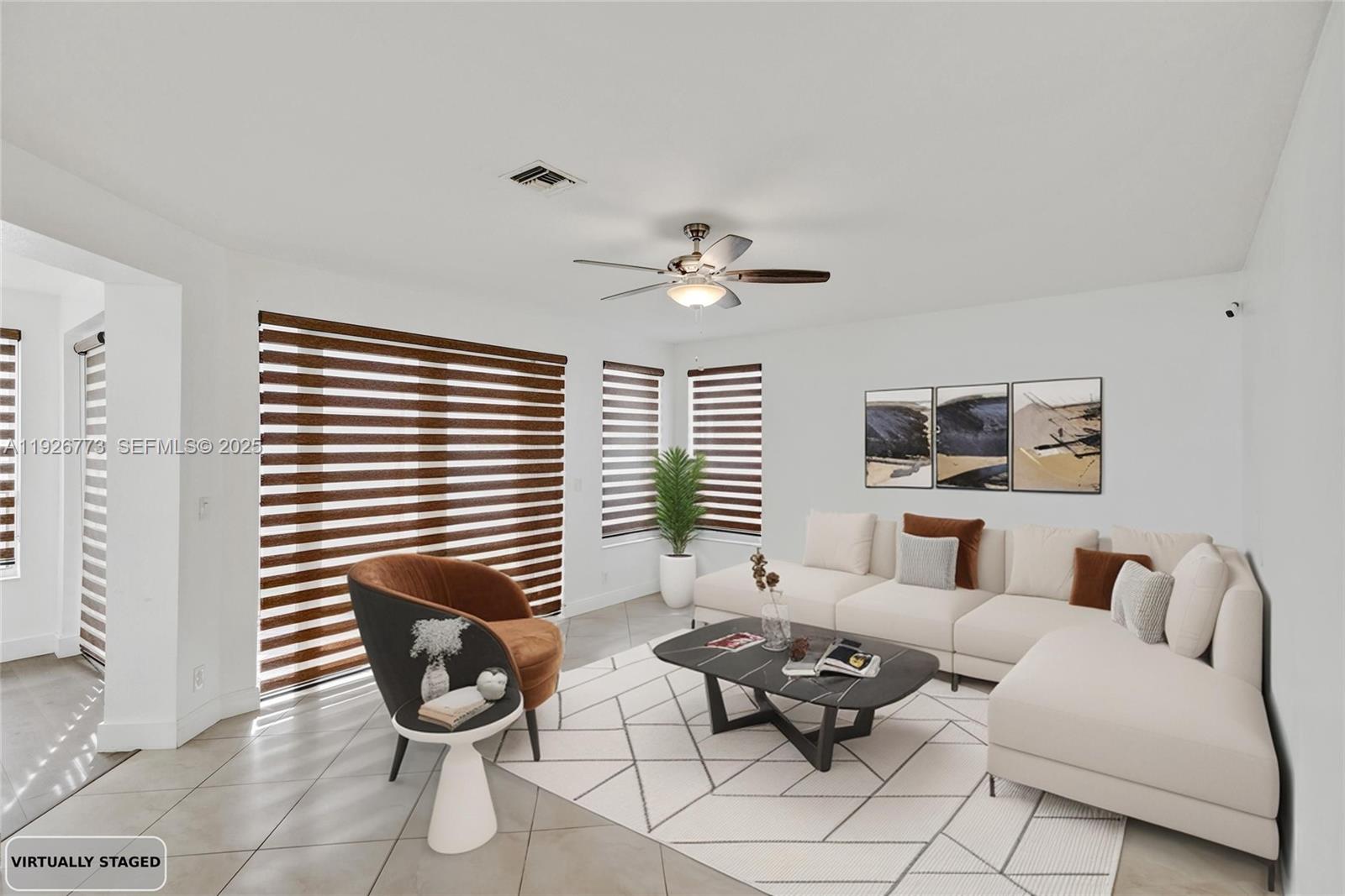 740 Cypress Pointe Drive East Pembroke Pines, FL 33027 - Photo 12 of 46 a living room with furniture and a large window