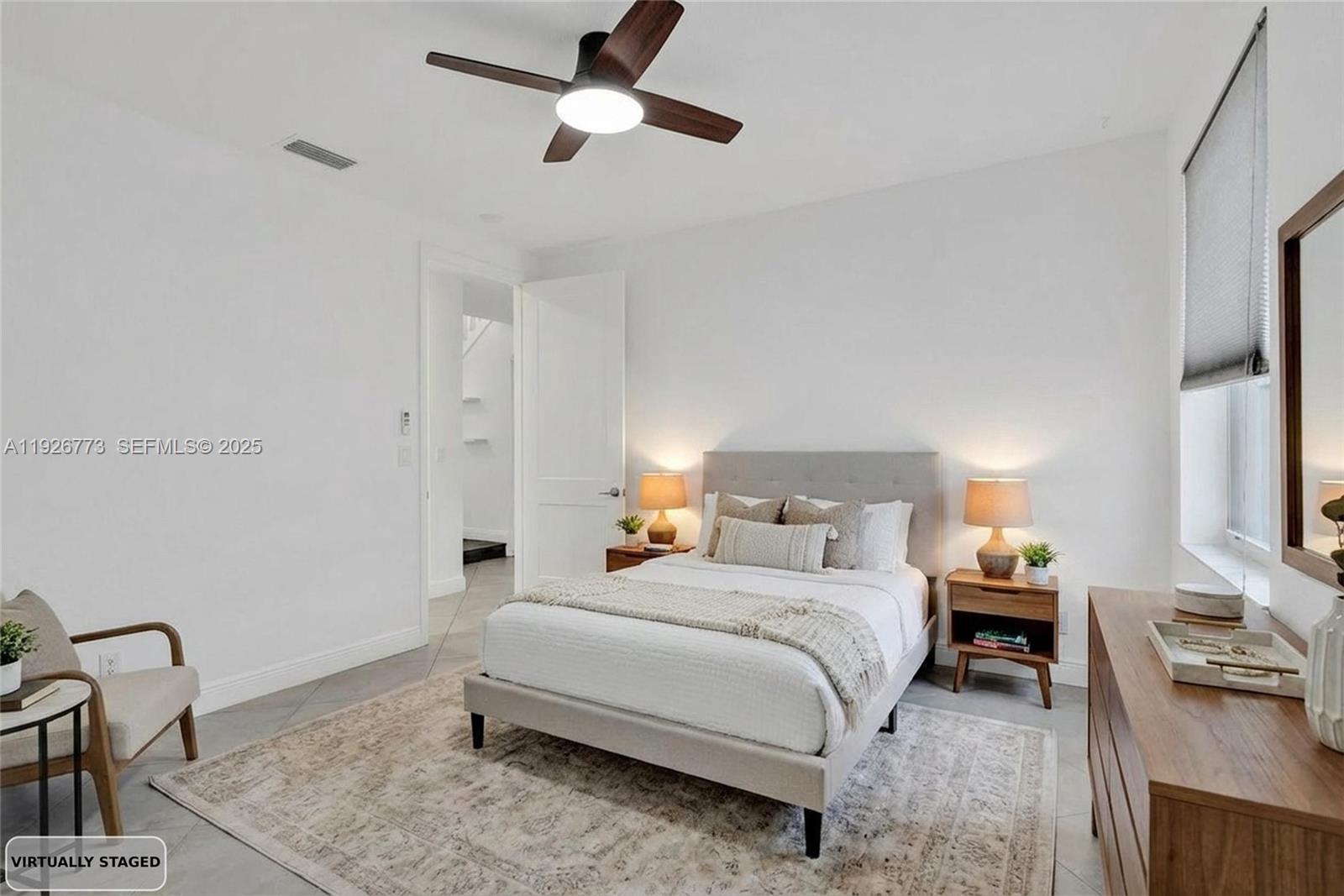 740 Cypress Pointe Drive East Pembroke Pines, FL 33027 - Photo 15 of 46 a bedroom with a bed and a dresser with the shoe rack