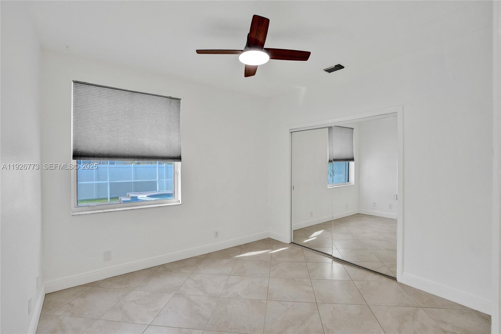 740 Cypress Pointe Drive East Pembroke Pines, FL 33027 - Photo 16 of 46 a view of an empty room with a window