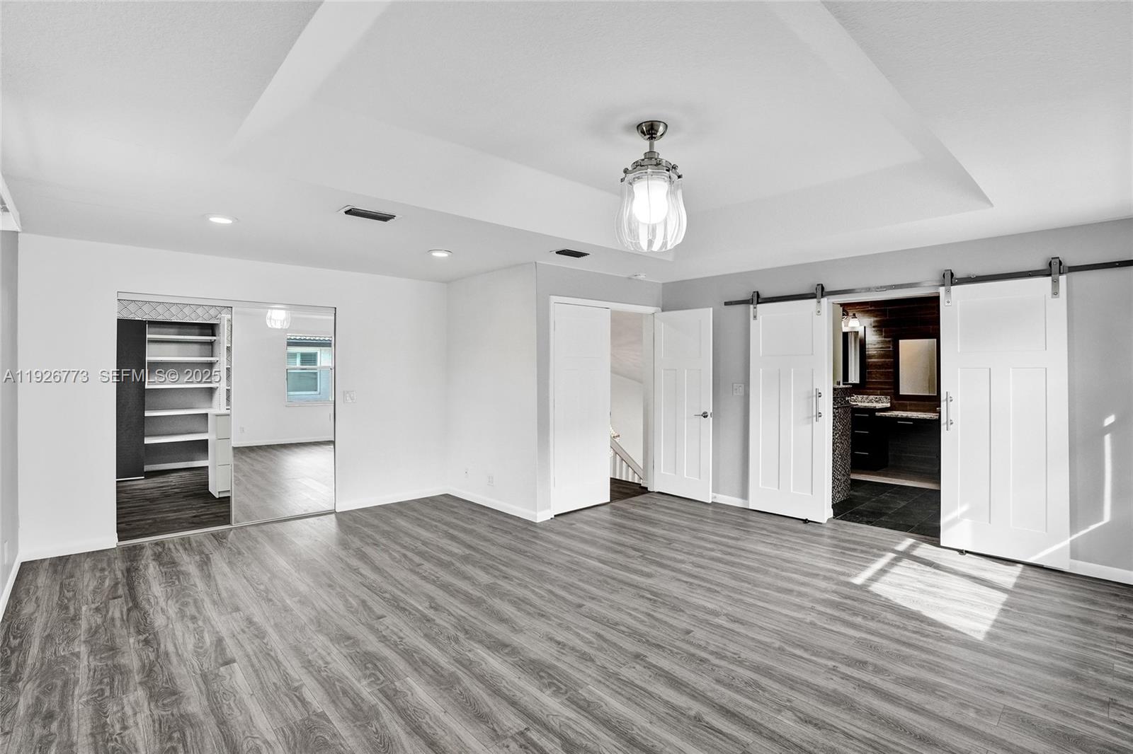 740 Cypress Pointe Drive East Pembroke Pines, FL 33027 - Photo 21 of 46 an empty room with wooden floor closet and windows