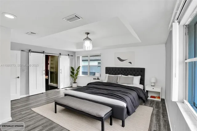 a bedroom with bed and wooden floor