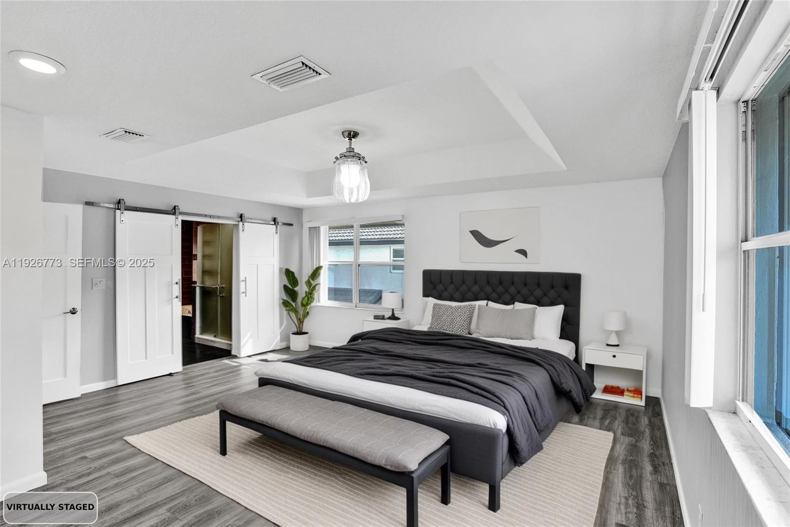 740 Cypress Pointe Drive East Pembroke Pines, FL 33027 - Photo 23 of 46 a bedroom with bed and wooden floor