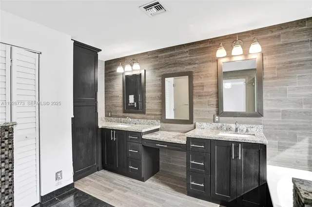 a bathroom with a double vanity sink and a mirror