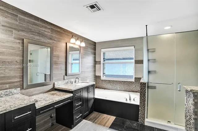 a bathroom with a granite countertop sink mirror and double