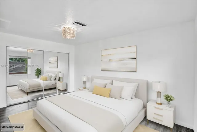 a bedroom with bed and wooden floor