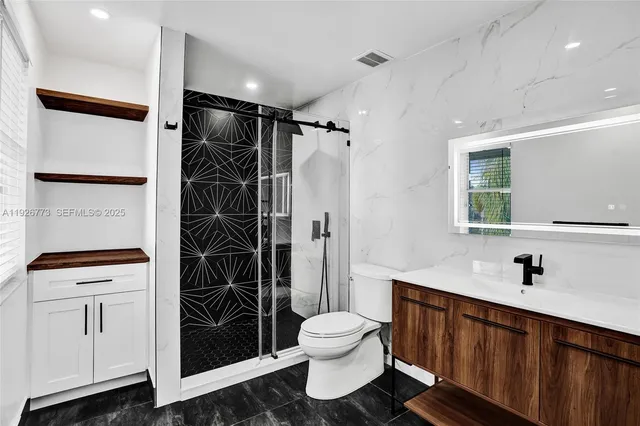 a bathroom with a sink toilet and shower