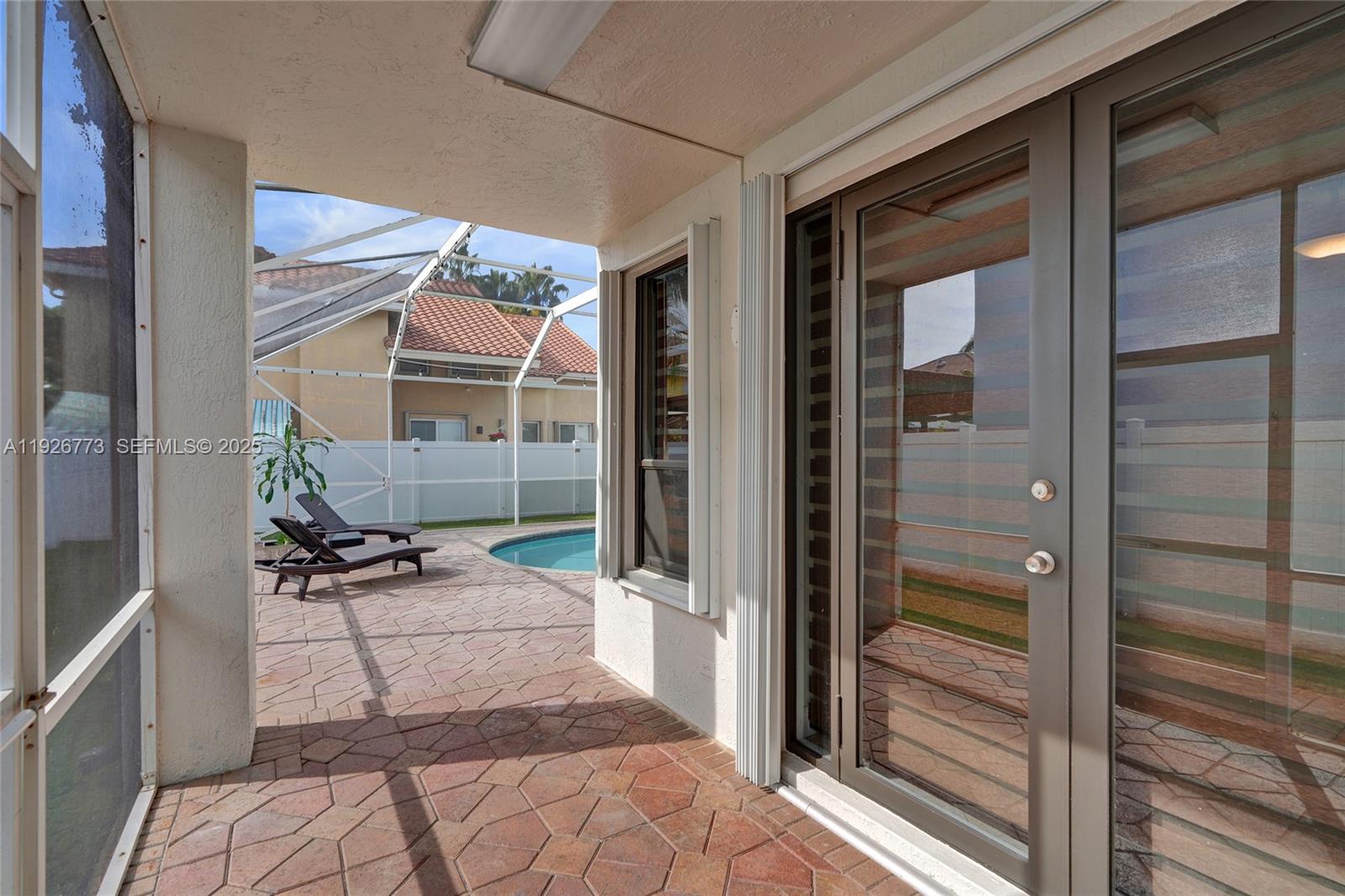 740 Cypress Pointe Drive East Pembroke Pines, FL 33027 - Photo 37 of 46 a patio with table and chairs