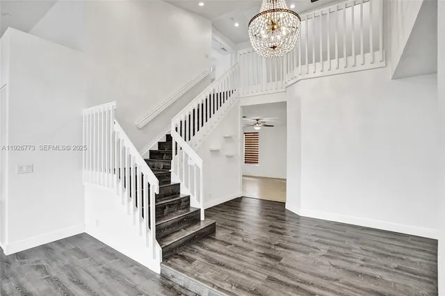 a view of entryway and hall with wooden floor